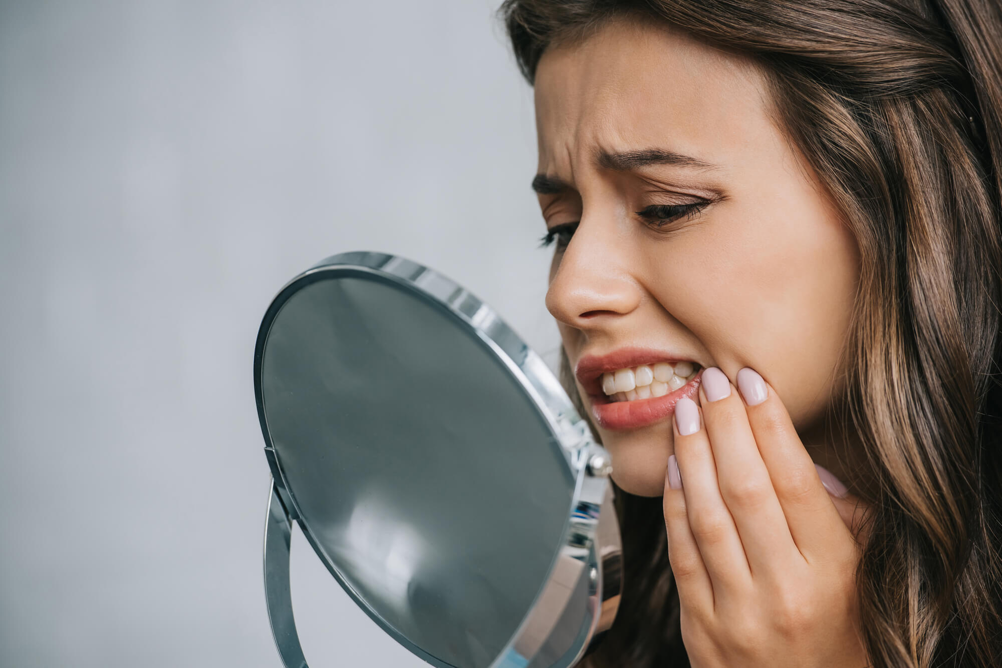 Woman in pain after a Tooth Extraction Denton