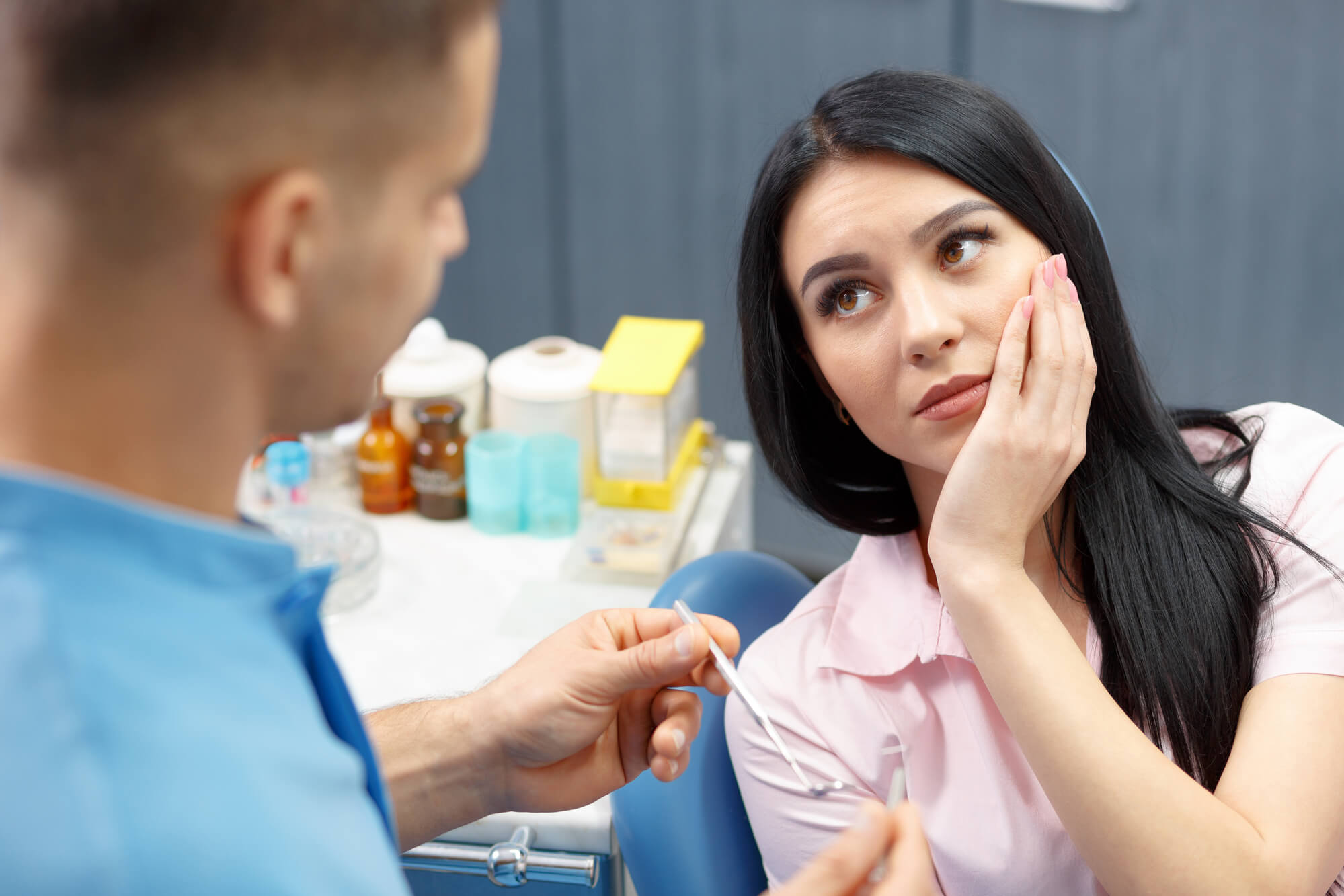 Woman in pain after getting Extractions 76210