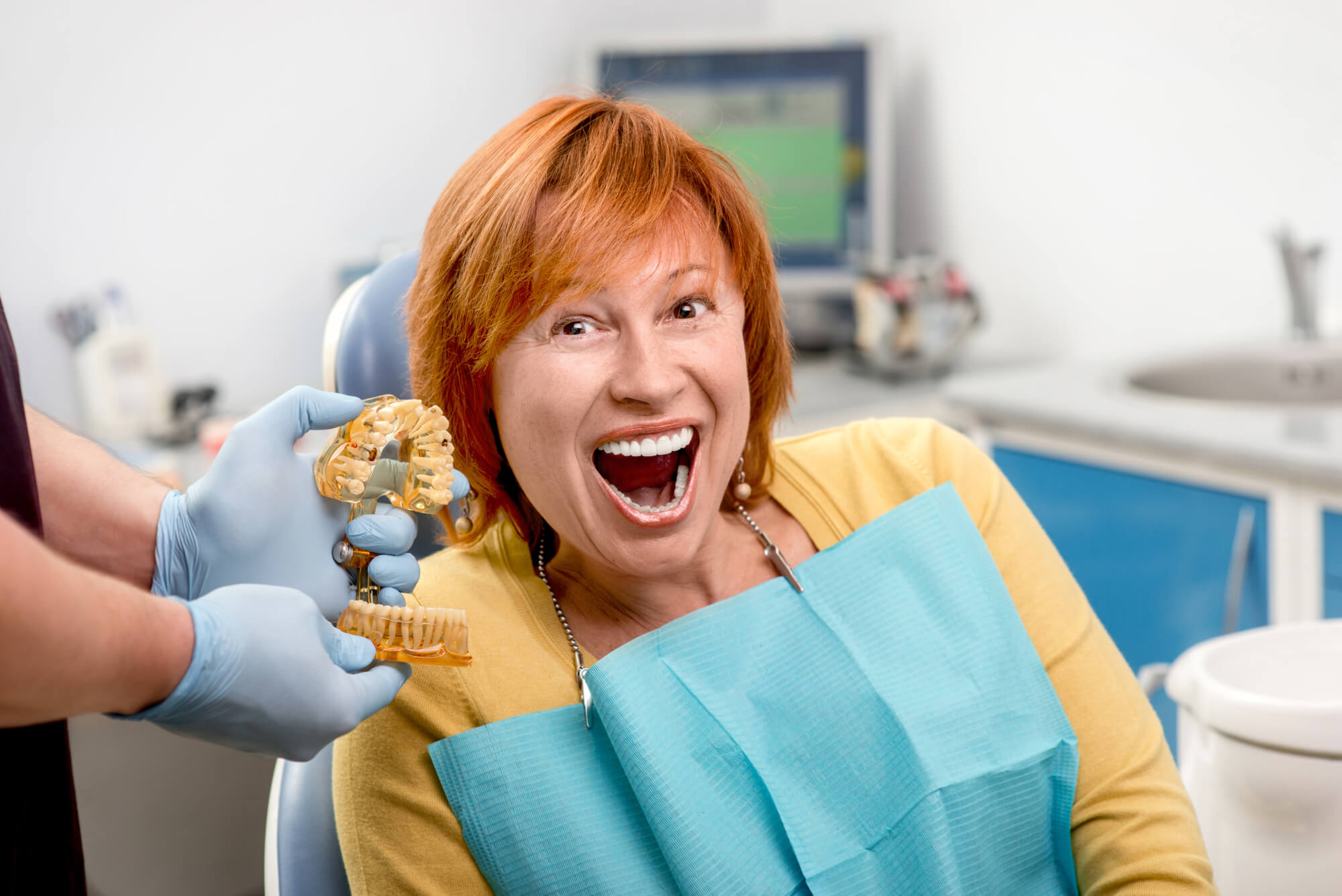 a woman with Dental Implants in Decatur sitting in dental chair