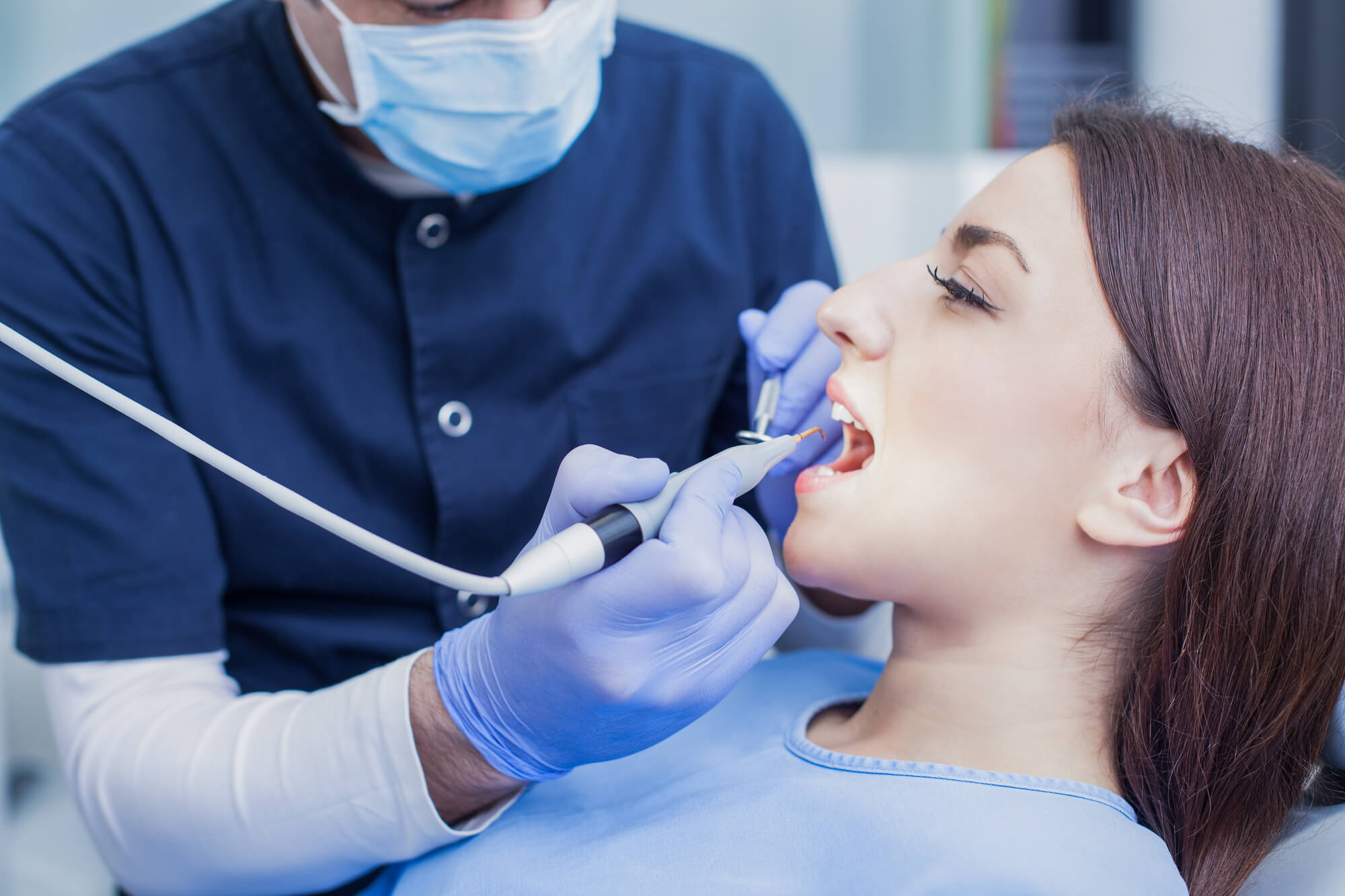 an expert in Oral pathology in Denton examining a patient's mouth