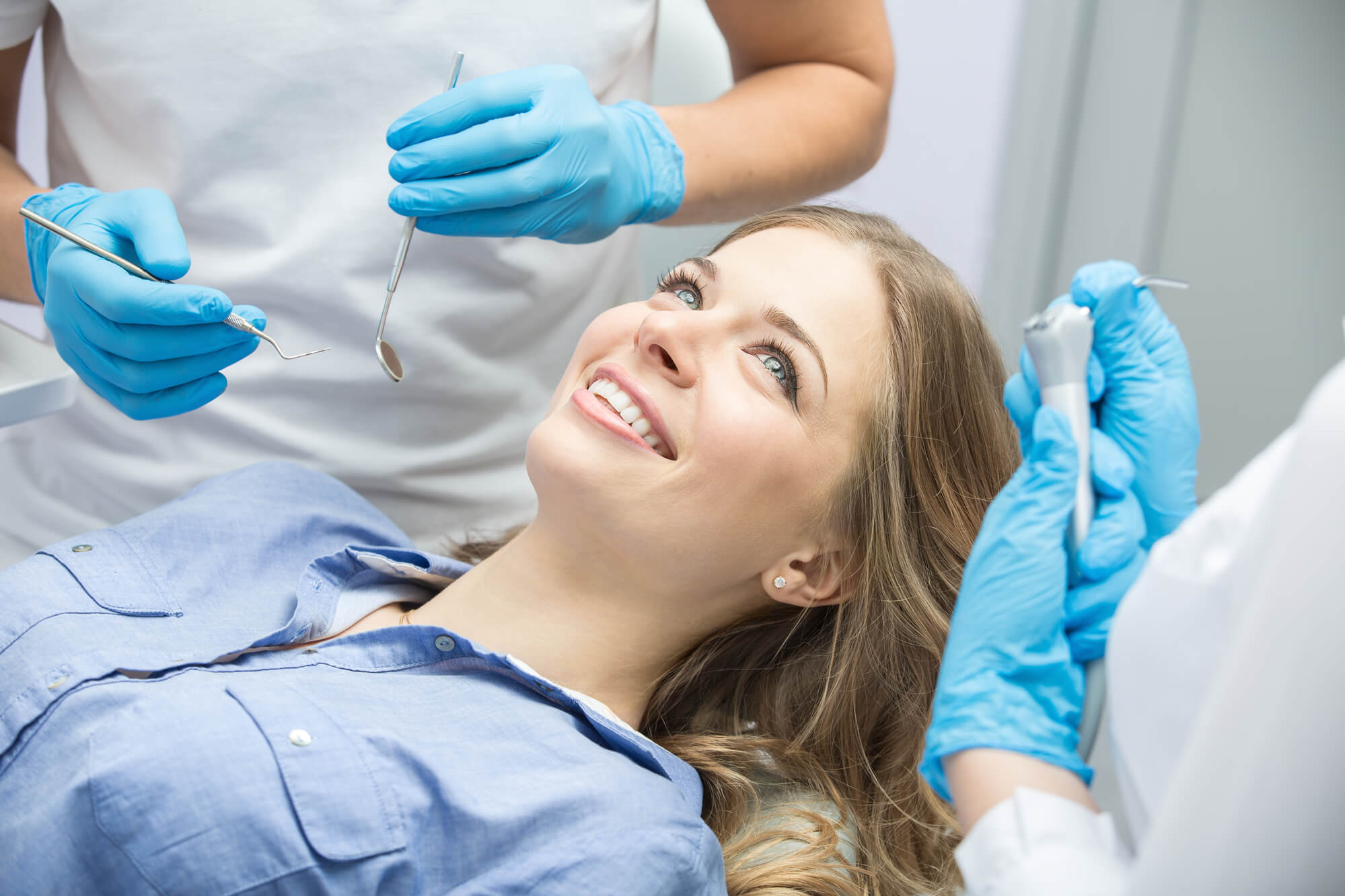 a patient sitting in the dental chair and smiling at the oral surgeon in Plano