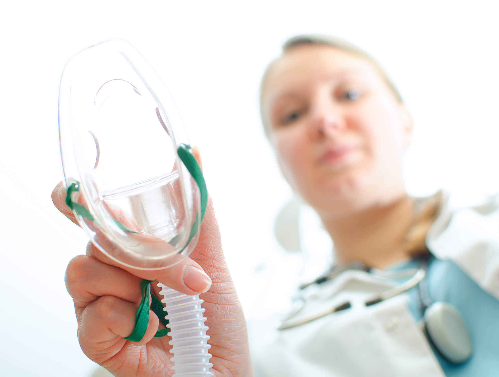Oral Surgeon in Plano putting on sedation mask