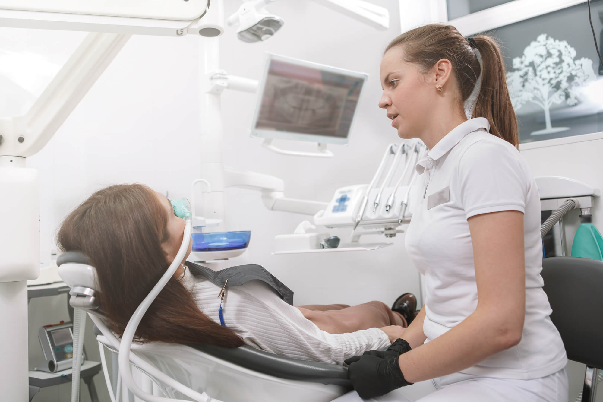 Oral Surgeon in Plano discuss treatment with patient