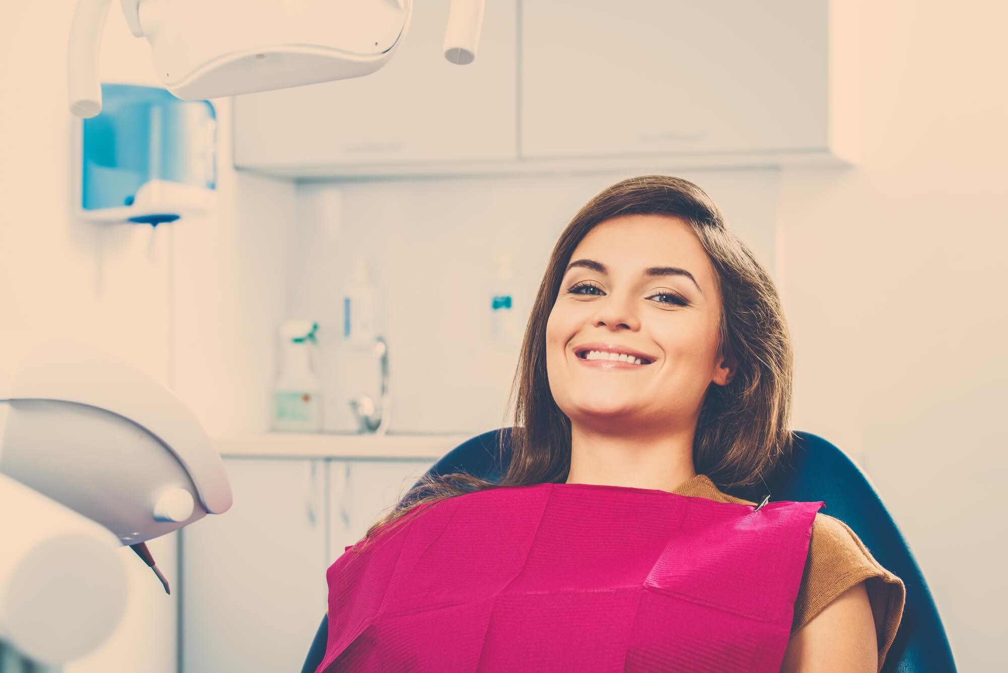 patient smiles at an oral surgeon in 76210
