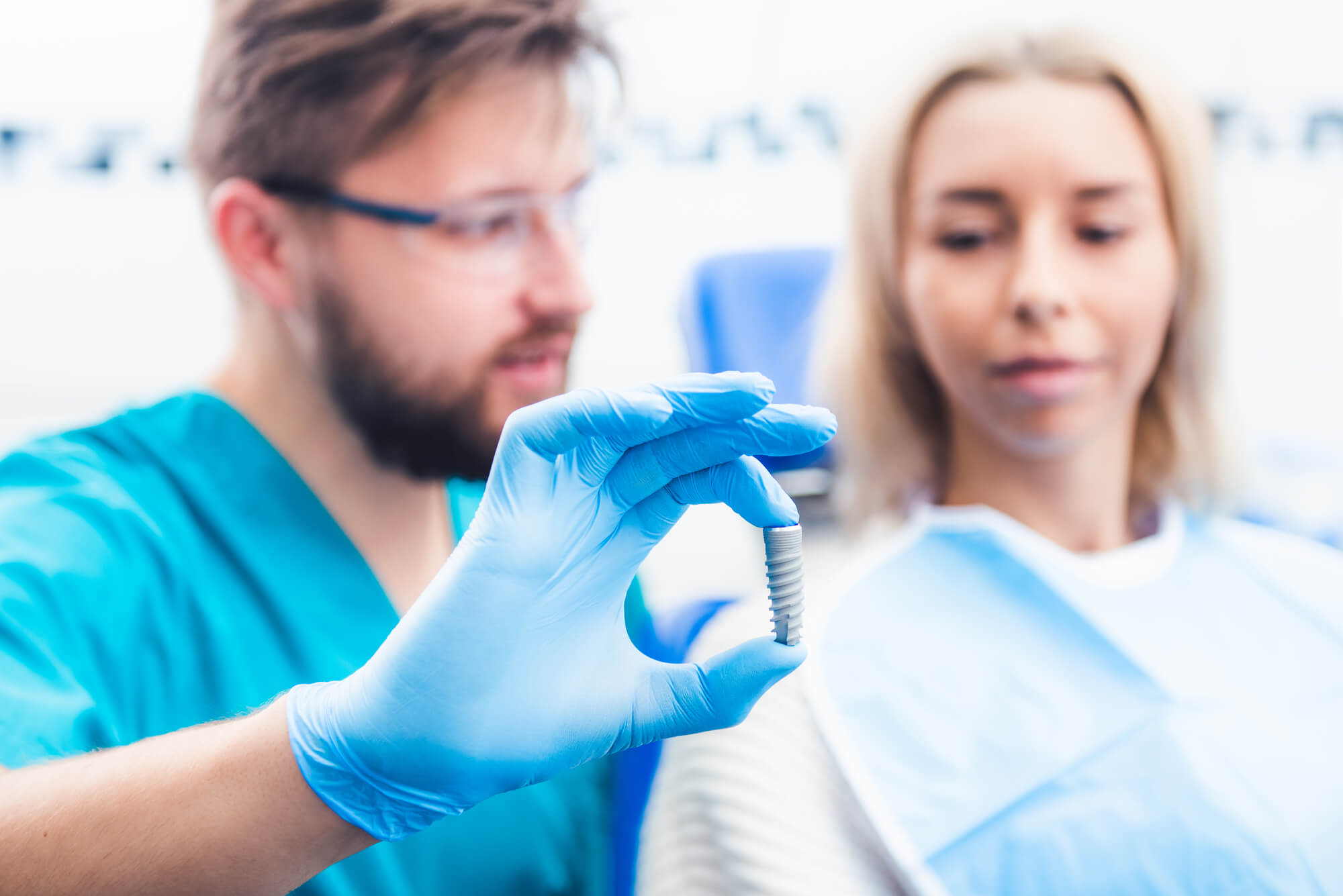 dentist shows samples of dental implants in Decatur