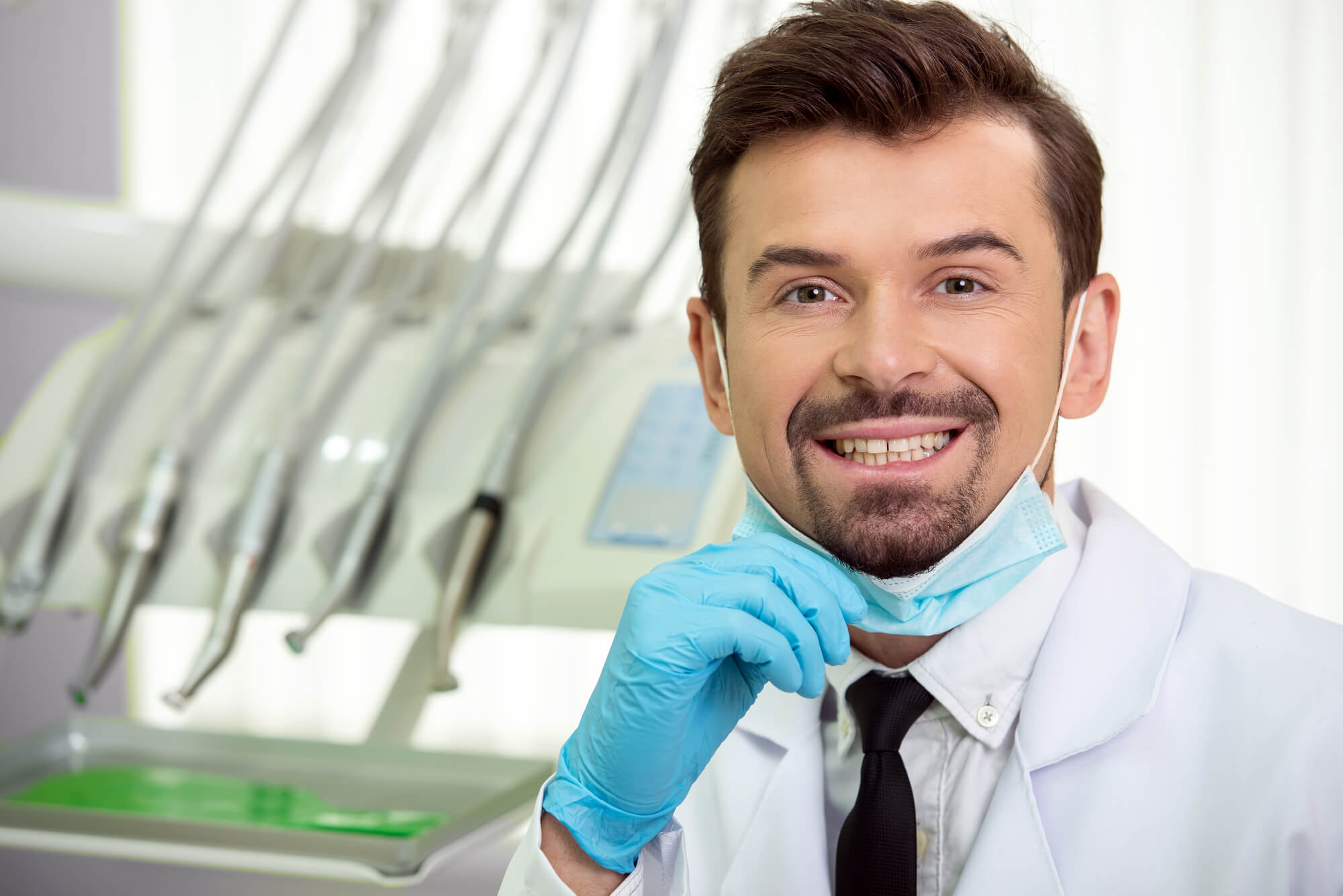 dentist smiles after extraction of wisdom teeth in Plano